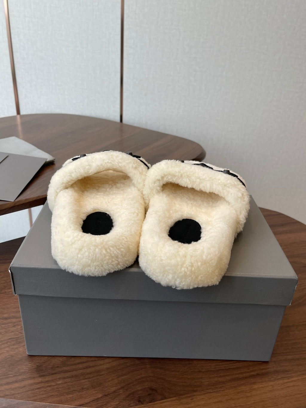 Balenciaga teddy slide sandals with cream fuzzy uppers and black footbeds, pair on box