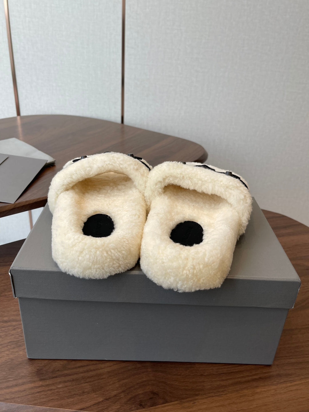 Balenciaga teddy slide sandals with cream fuzzy uppers and black footbeds, pair on box