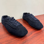 Navy suede Prada sneakers with lace-up design and stitched side panel shapes