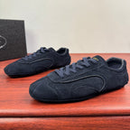 Navy suede lace-up Prada sneakers with curved side stripes and padded tongue