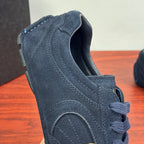 Navy suede Prada sneaker heel view with stitched seams and lace-up opening