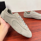 Light gray suede sneakers with lace-up front, viewed from side