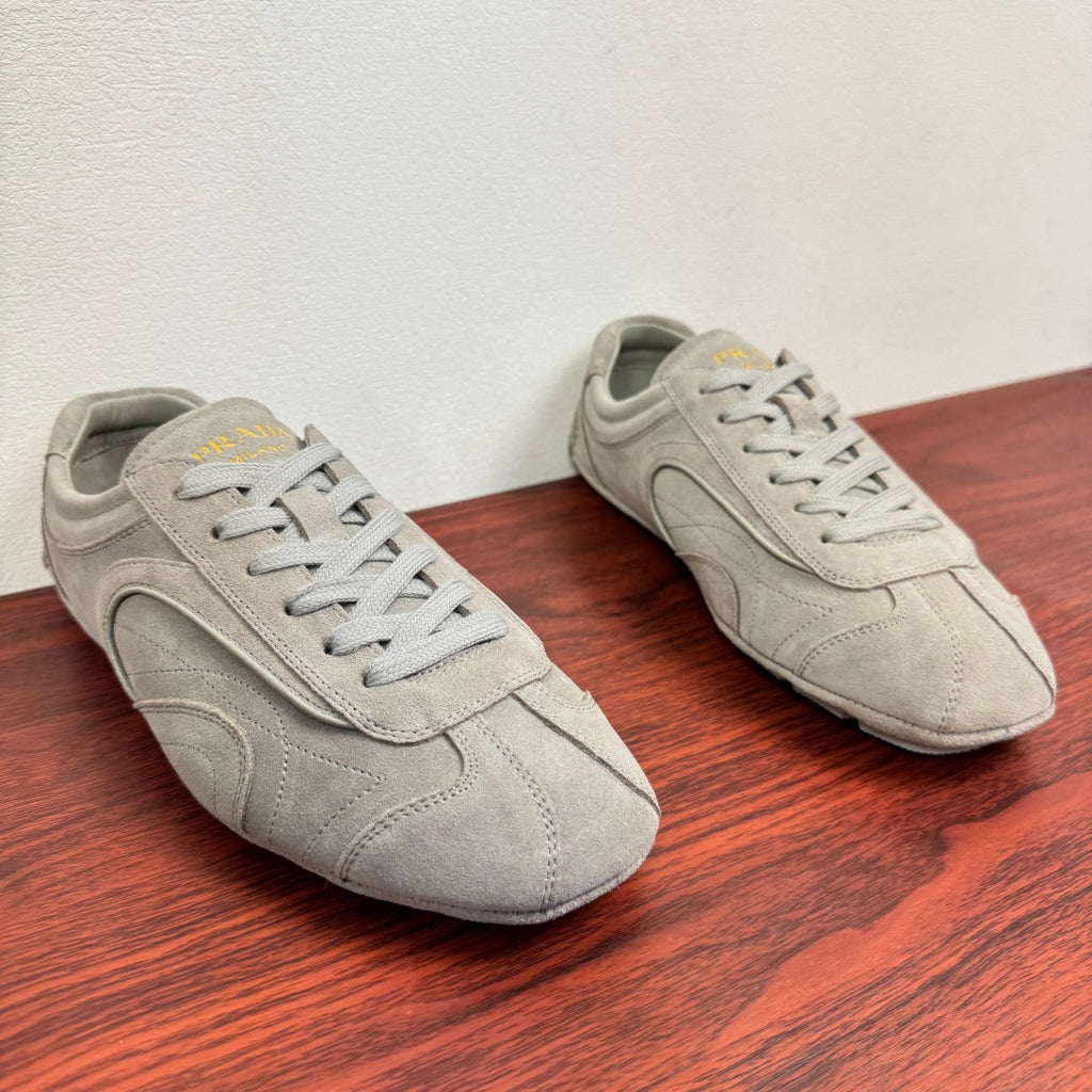 Light gray suede sneakers, side view, lace-up with padded collar