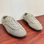 Light gray suede sneakers, side view, lace-up with padded collar