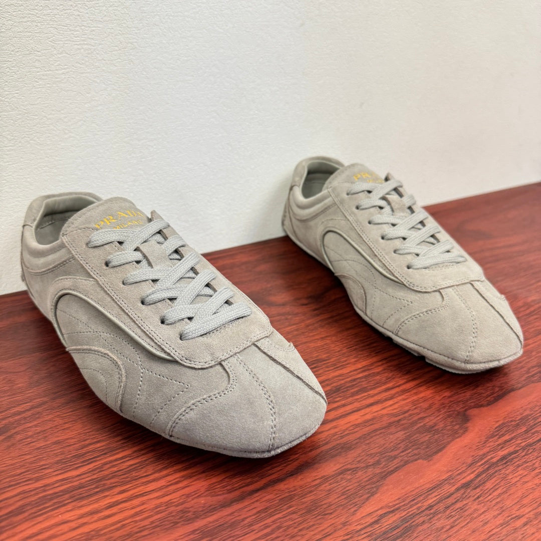 Light gray suede sneakers, side view, lace-up with padded collar