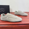 Light gray suede sneakers with lace-up front and rubber sole