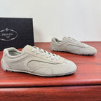 Light gray suede sneakers with lace-up front and rubber sole