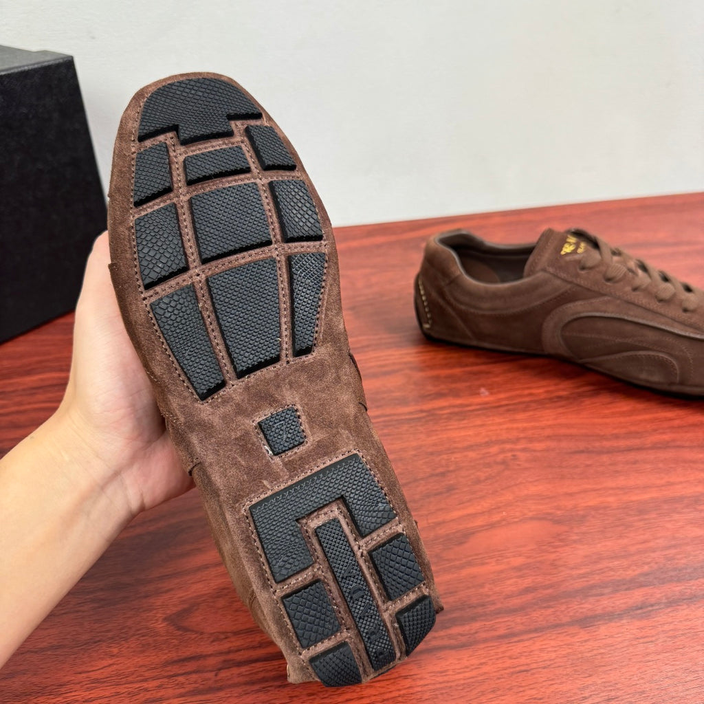 Brown suede sneaker sole with geometric tread and traction grooves