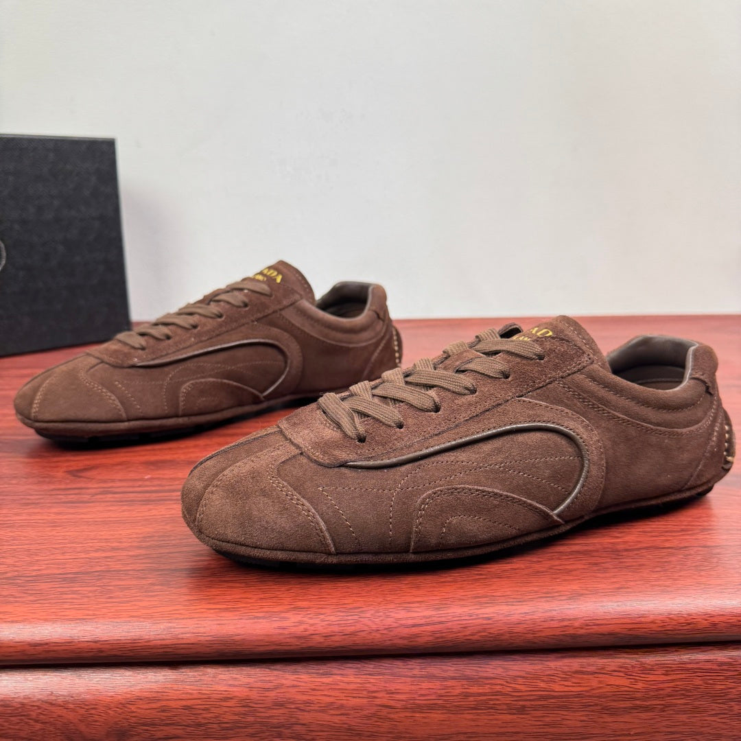 Brown suede lace-up sneakers with oval side logo and textured sole