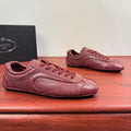 Prada unisex leather sneakers in burgundy with lace-up front and stitched overlays
