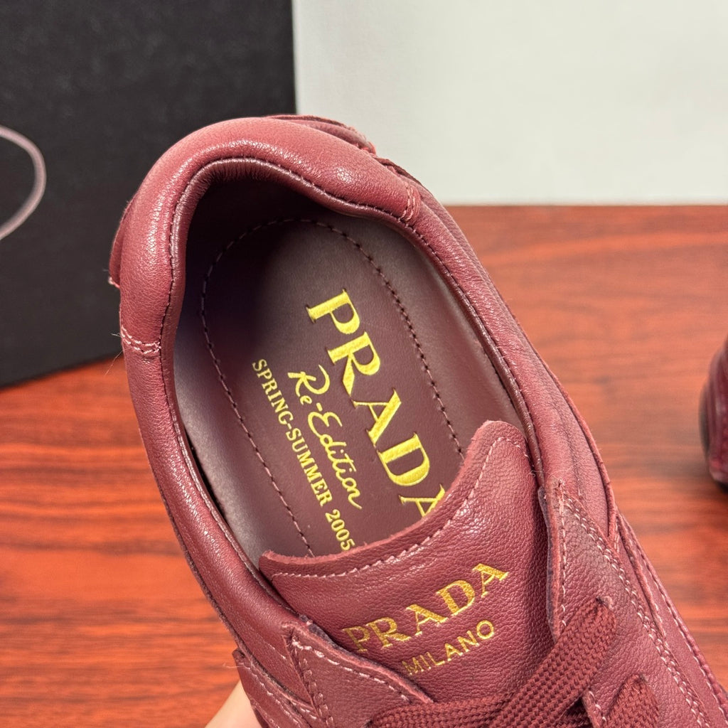 Prada unisex sneaker interior in burgundy leather with PRADA logo and lining
