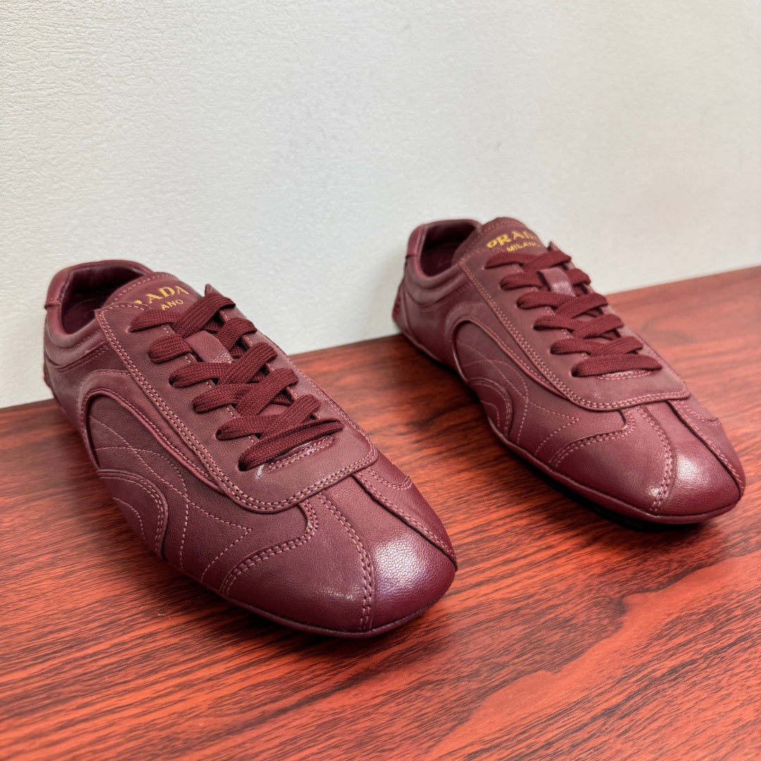 Prada unisex leather sneakers, burgundy, lace-up with side stripe and logo tongue