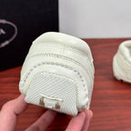 White sneaker outsole toe section with textured grip and embossed detail