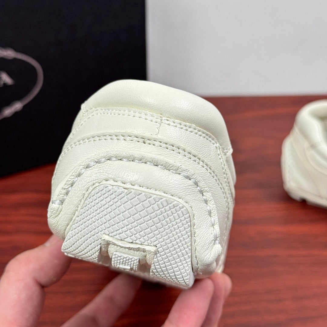 White sneaker outsole toe section with textured grip and embossed detail