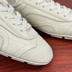 White leather lace-up sneakers close-up of laces and side stitching