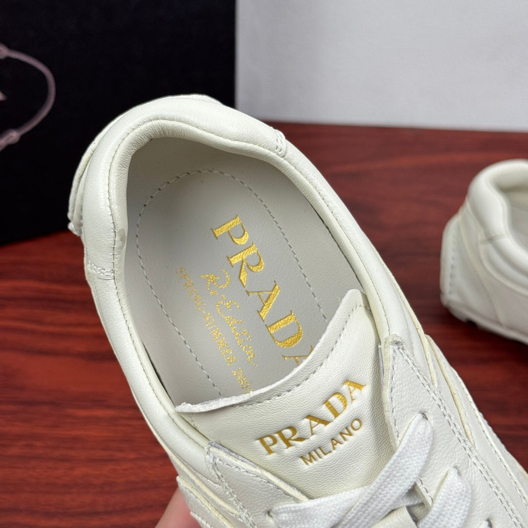 Prada white leather sneakers, interior tongue lining with PRADA MILANO text