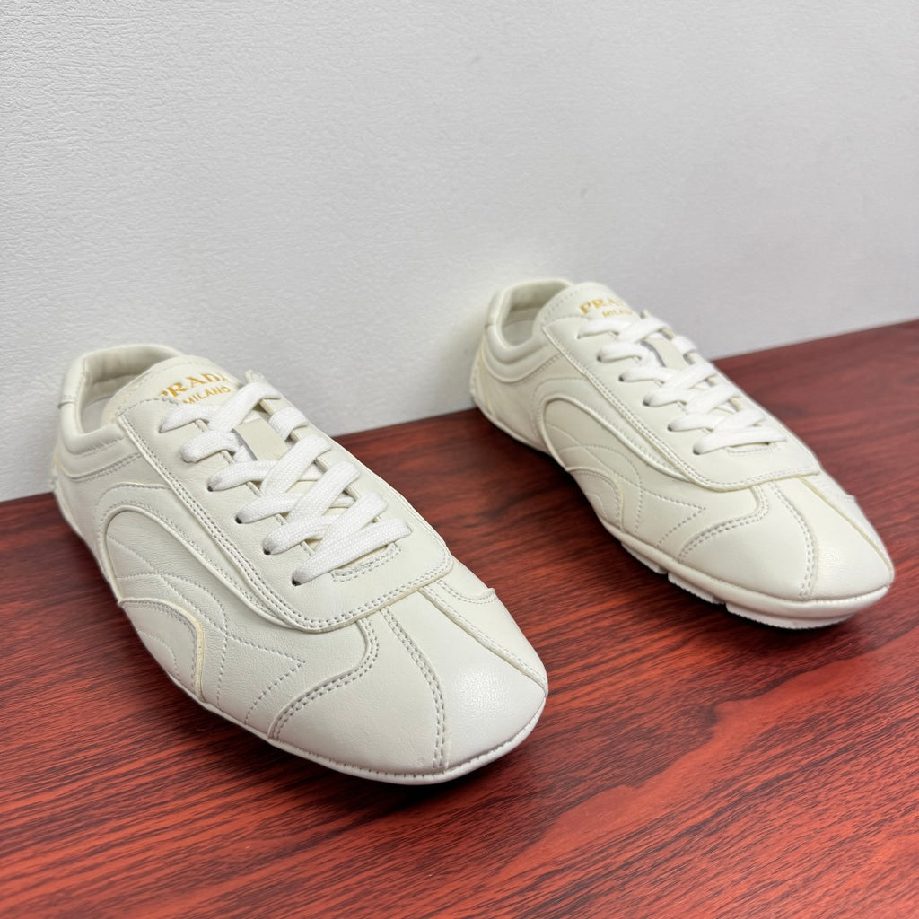 White leather lace-up sneakers, two pairs shown from side angle
