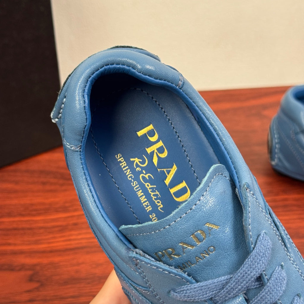 Light blue unisex sneaker interior with PRADA logo on the insole