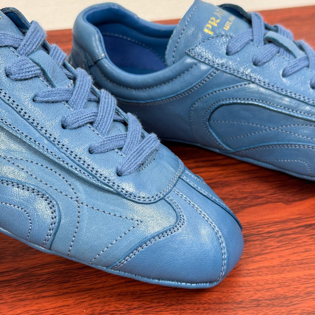 Light blue unisex sneakers close-up showing laces and stitched panel lines