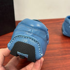 Light blue unisex sneakers with black rubber sole edge and tread pattern