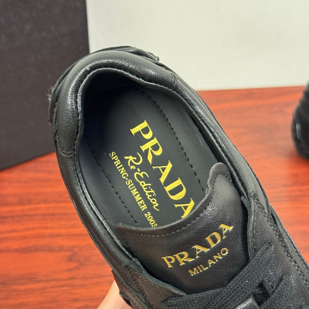 Prada unisex sneakers, interior label close-up, dark insole with Prada logo