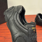 Prada unisex sneakers, close-up of side heel, textured dark leather and logo patch
