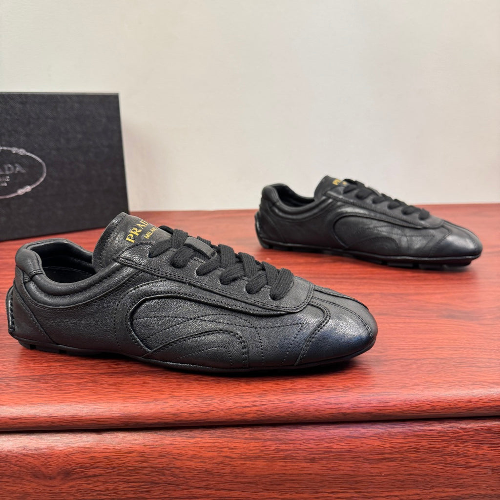 Prada unisex sneakers in dark leather with lace-up front and stitched panels