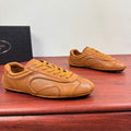 Tan Prada unisex sneakers with yellow laces and stitched panel details