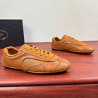Tan Prada unisex sneakers with yellow laces and stitched panel details