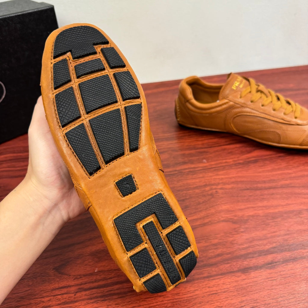Tan sneaker outsole with dark tread grid pattern and block details