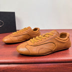 Tan Prada unisex sneakers, lace-up style with curved toe and side paneling