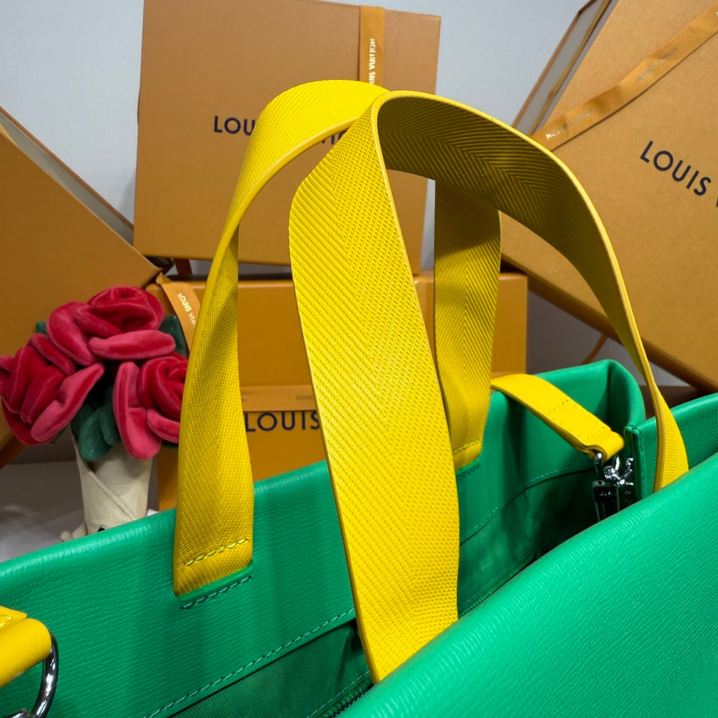 Louis Vuitton green tote bag with tall yellow handles and visible front corner
