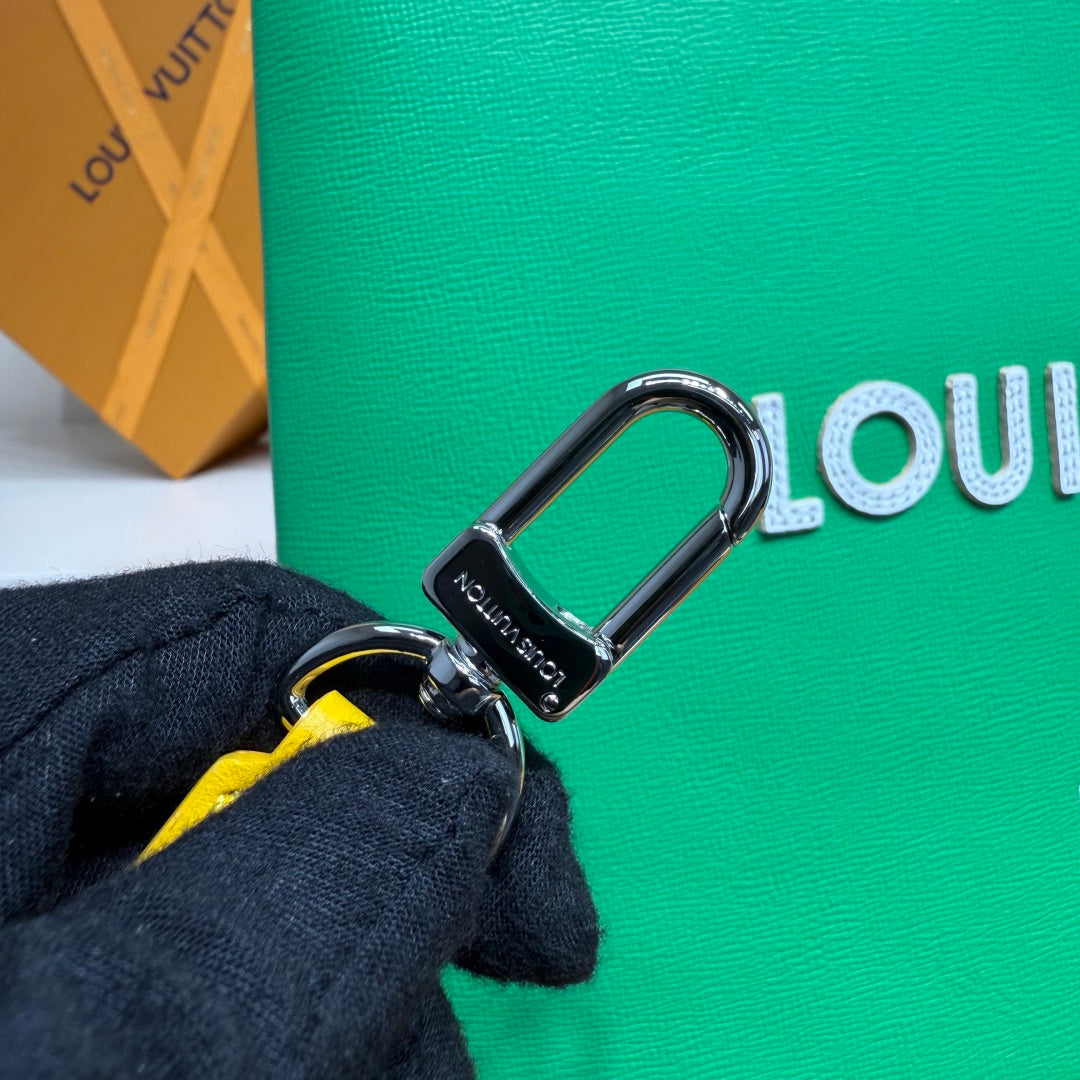Louis Vuitton green bag with silver D-ring and yellow strap accent