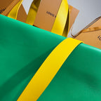 Louis Vuitton green tote bag fabric with yellow strap detail over the edge