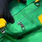 Louis Vuitton green leather zip bag with silver zipper pull and logo tag