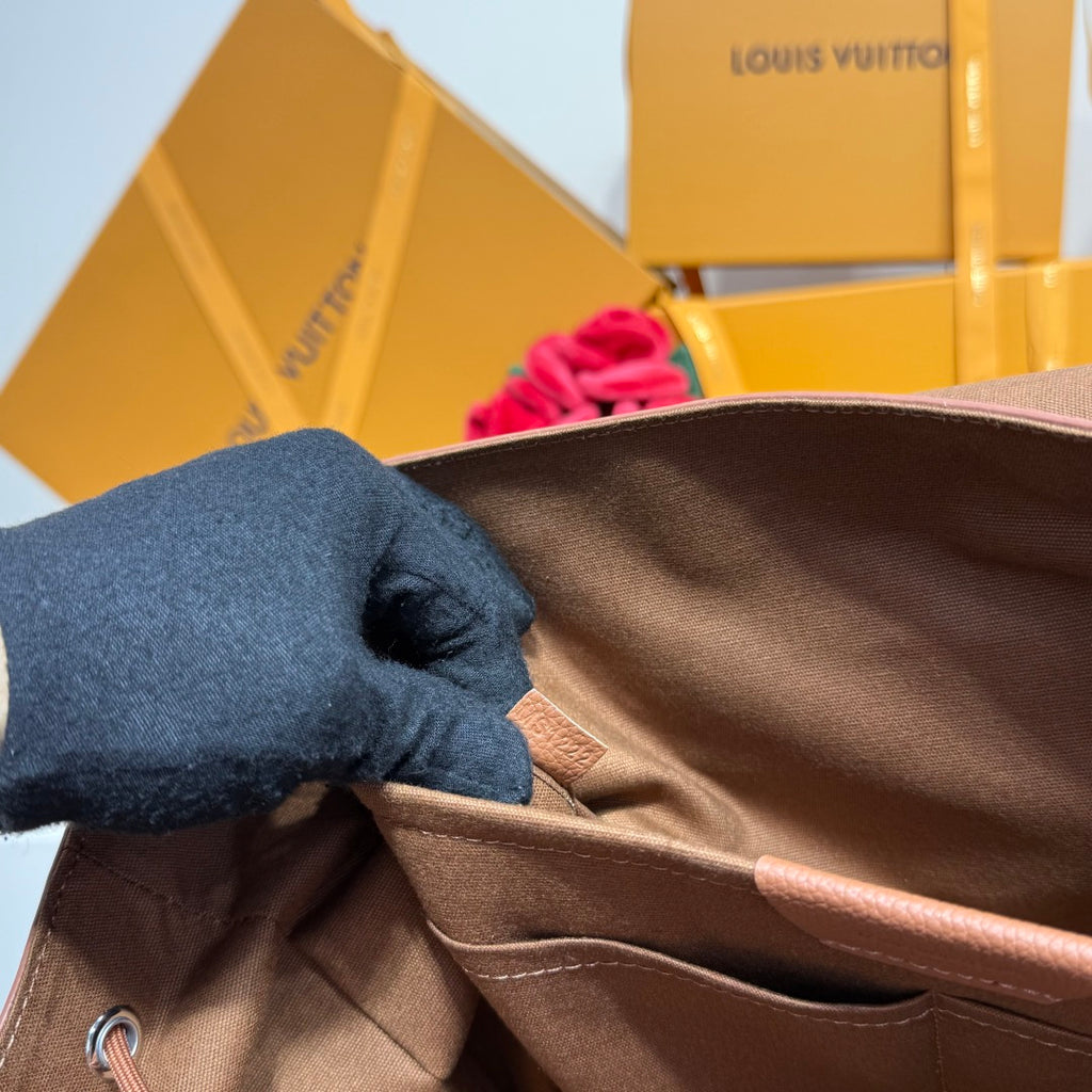 Close-up of backpack interior lining with side pocket and drawstring cords.