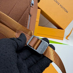 Men’s Louis Vuitton backpack detail: adjustable strap with metal buckle and zipper edge