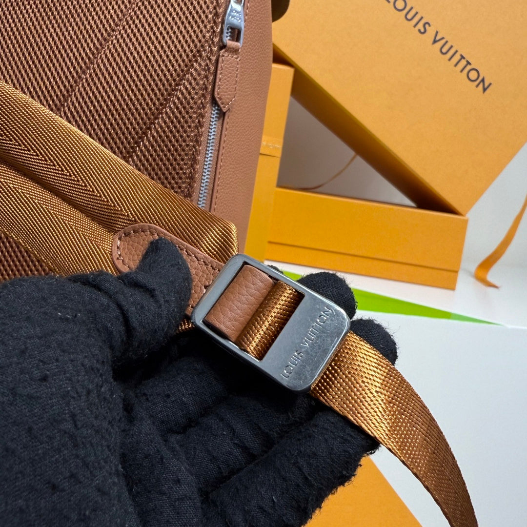 Men’s Louis Vuitton backpack detail: adjustable strap with metal buckle and zipper edge