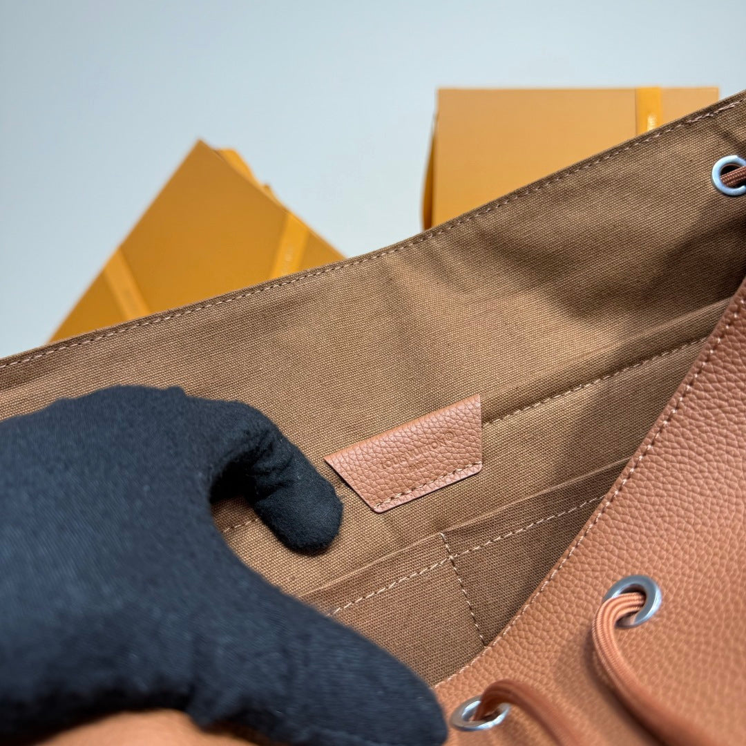 Close-up of interior lining and stitched pocket near drawstring grommets on the bag.