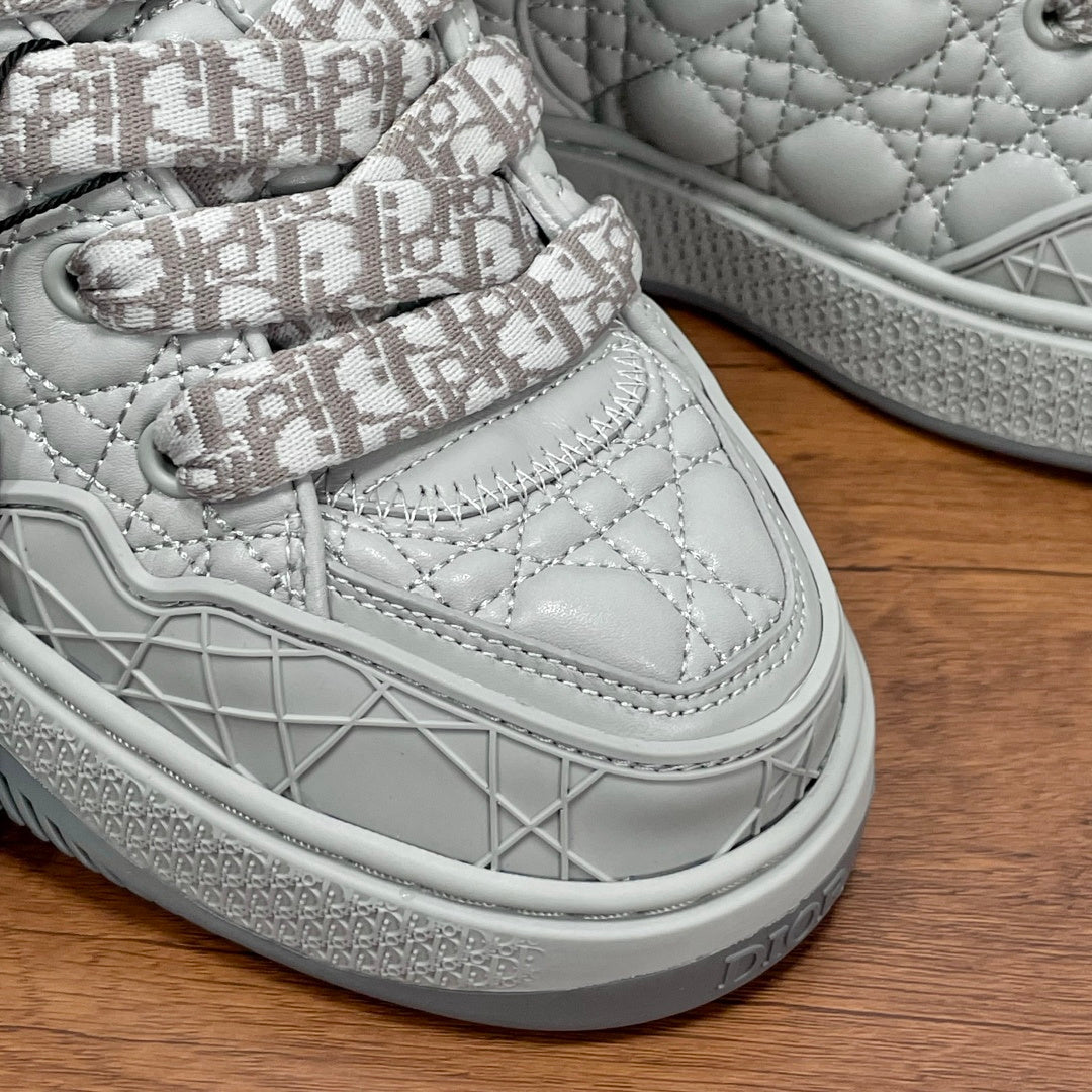 White low-top sneaker with Dior monogram laces, stitched detailing, and textured sole