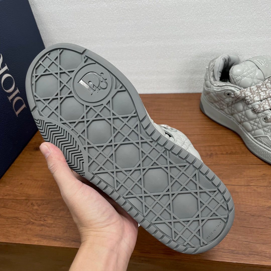 Dior sneaker outsole, grey rubber tread with geometric grid and round logo