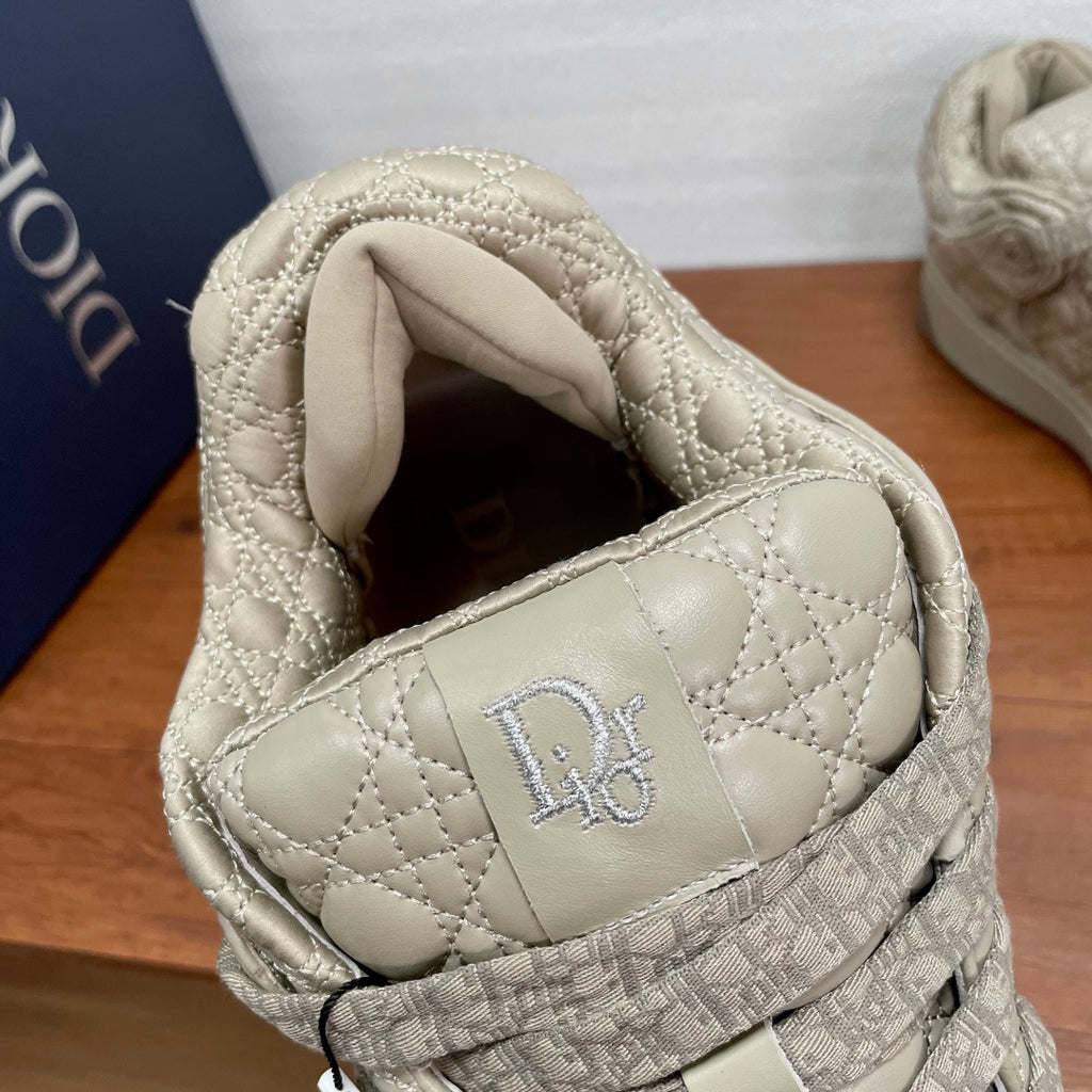 Cream sneaker opening with padded collar and embroidered D logo on inner side