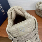 Cream sneaker opening with padded collar and embroidered D logo on inner side