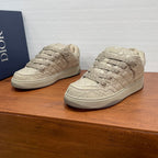 Quilted beige lace-up sneakers with textured toe cap and rubber sole