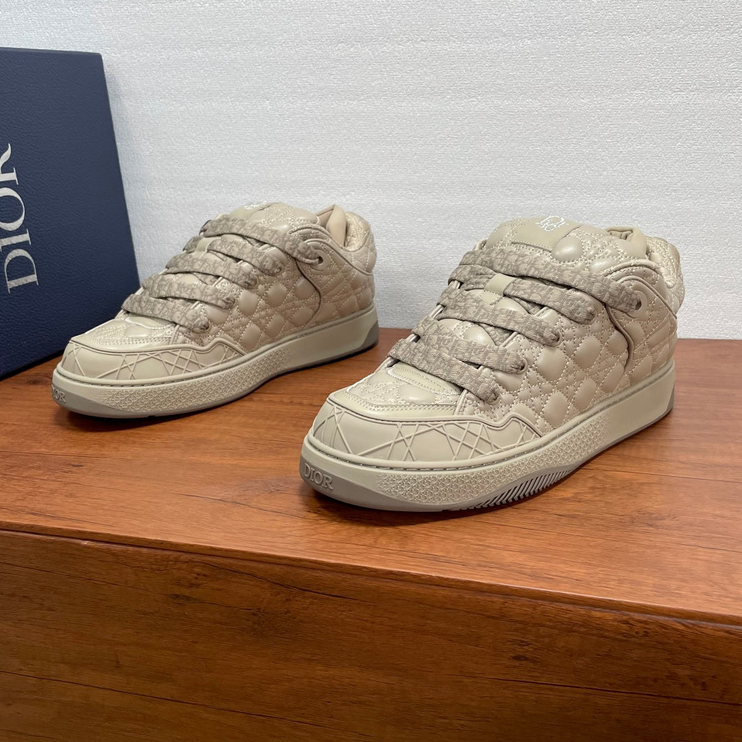 Quilted beige lace-up sneakers with textured toe cap and rubber sole