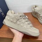 Beige quilted lace-up sneaker with textured overlays and side logo patch
