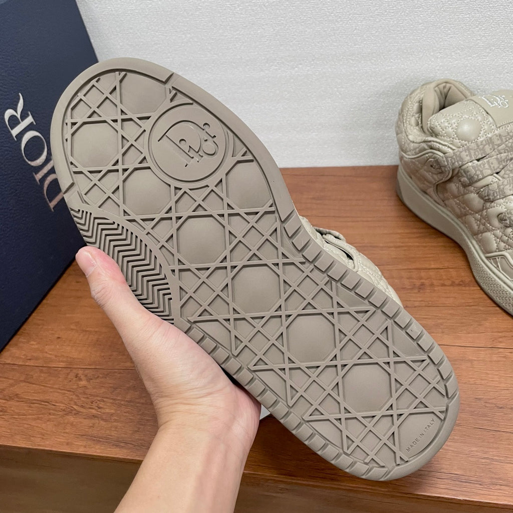 Beige sneaker outsole with geometric tread pattern and lace-up style upper