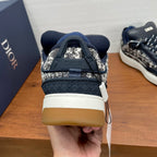 Back view of Dior lace-up sneaker in navy with silver pattern and white heel panel