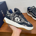 Unisex lace-up sneaker in navy and silver speckled textile, white midsole, side logo