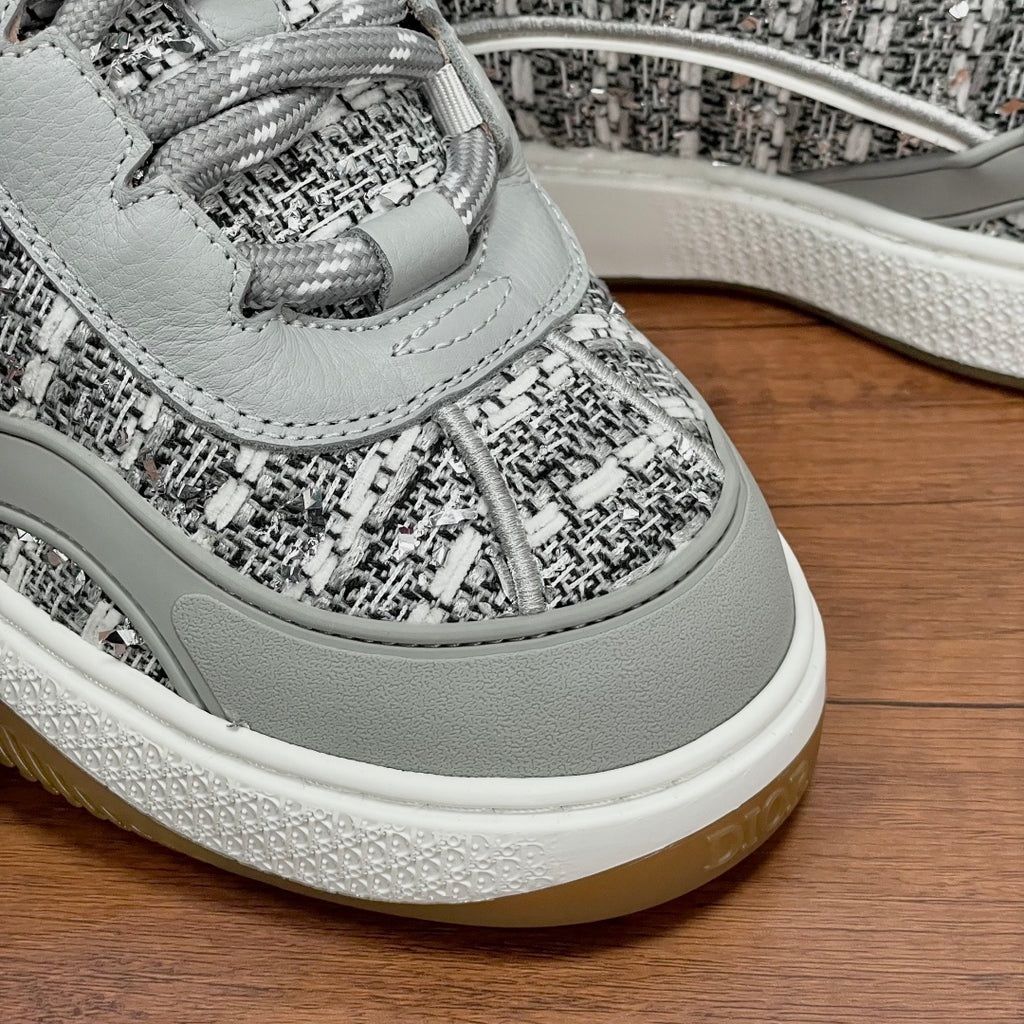 Light gray lace-up sneaker with braided laces and patterned upper detail